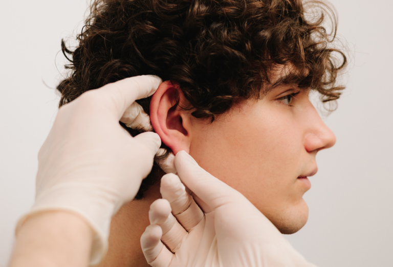 ear pinning male with doctor touching ear