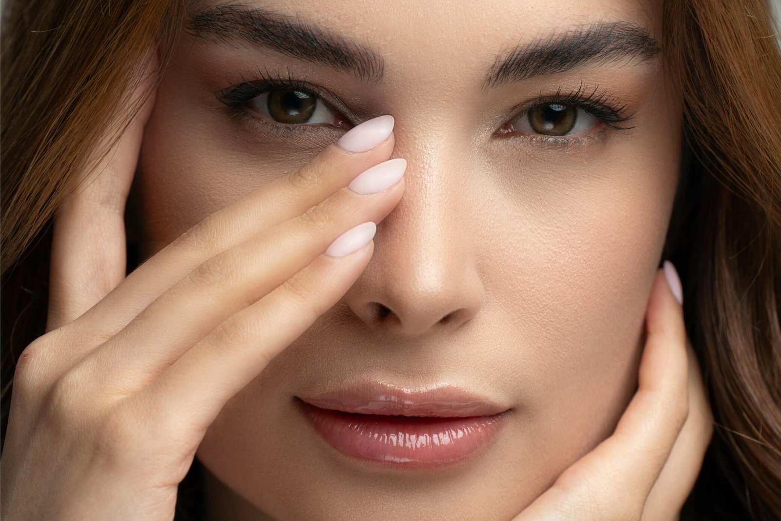 Close-up portrait of an adult woman with natural beauty and elegant makeup.